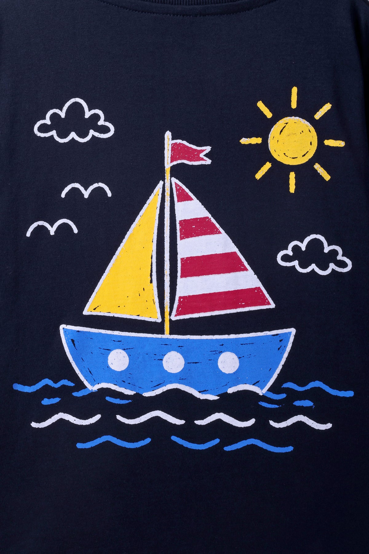 Close-up of navy T-shirt sailboat print with sun, clouds, and waves