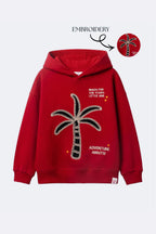 Red fleece hoodie with palm tree embroidery and 'Adventure awaits' text