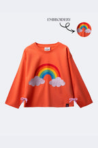 Girl’s coral long-sleeve T-shirt with rainbow and embroidered clouds, bow hem