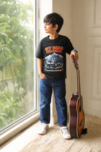 Black Off Road Exploring graphic tee on child, paired with blue jeans and sneakers
