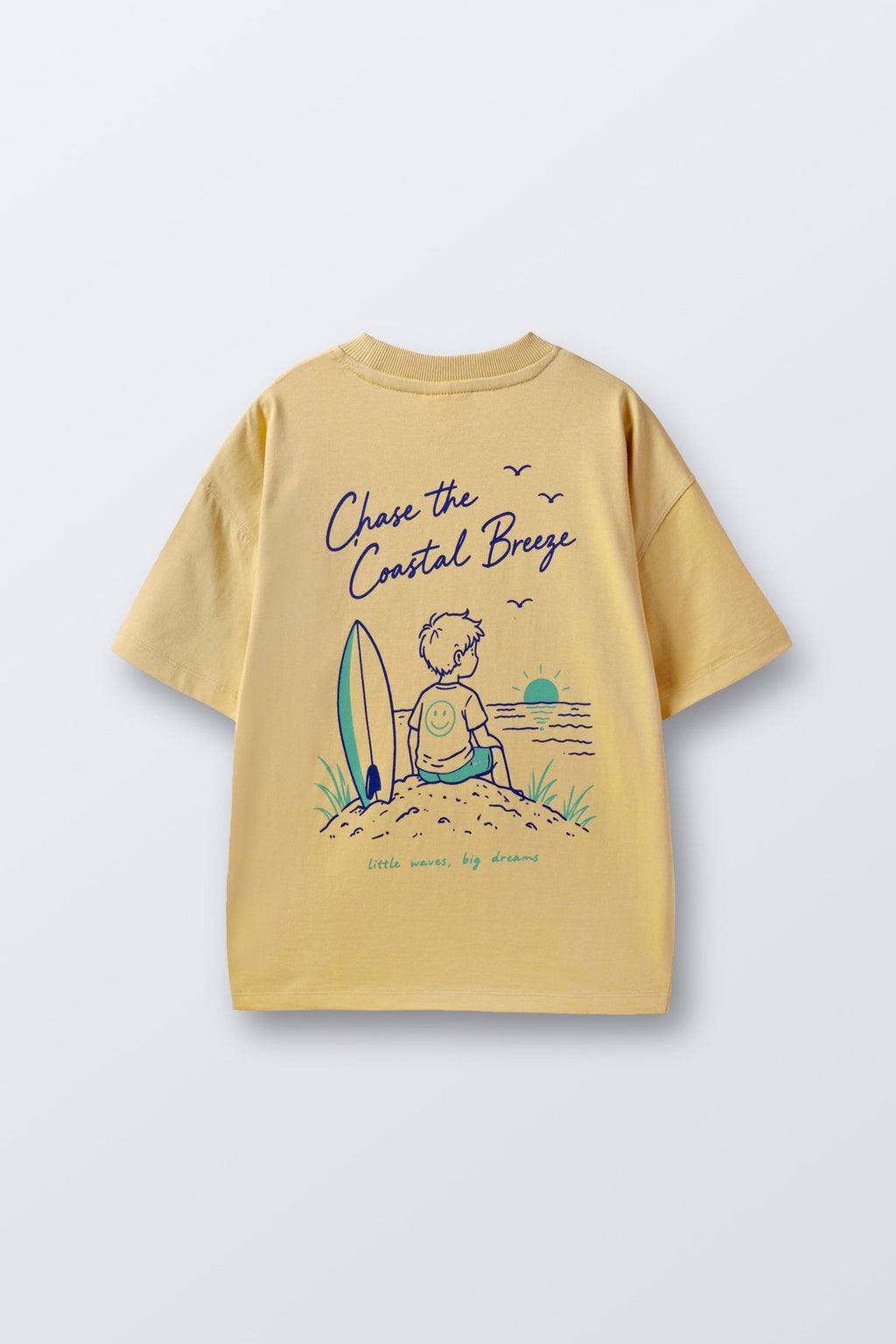 Sand yellow graphic tee with surf-kid illustration and 'Chase the Coastal Breeze' text.