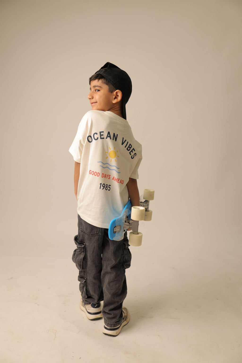 Off-white comfort tee with “Ocean Vibes” front graphic worn by a child