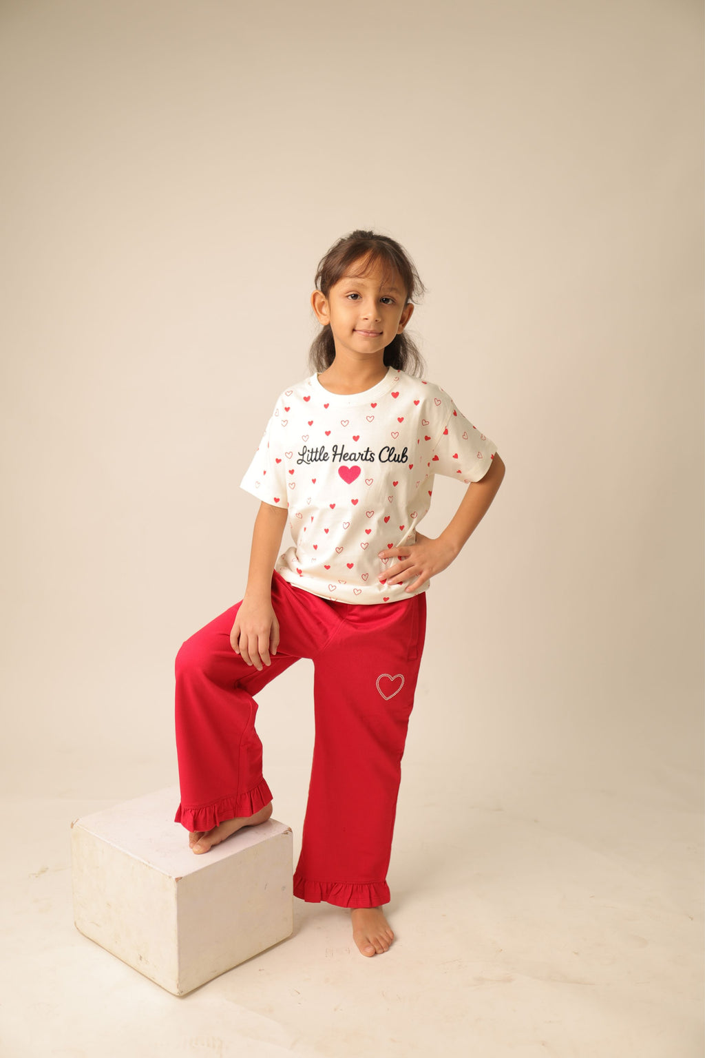 Off-white kids comfort tee with red heart print and 'Little Hearts Club' on chest