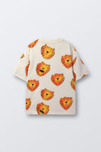 White t-shirt laid flat with orange lion face print pattern, angled view
