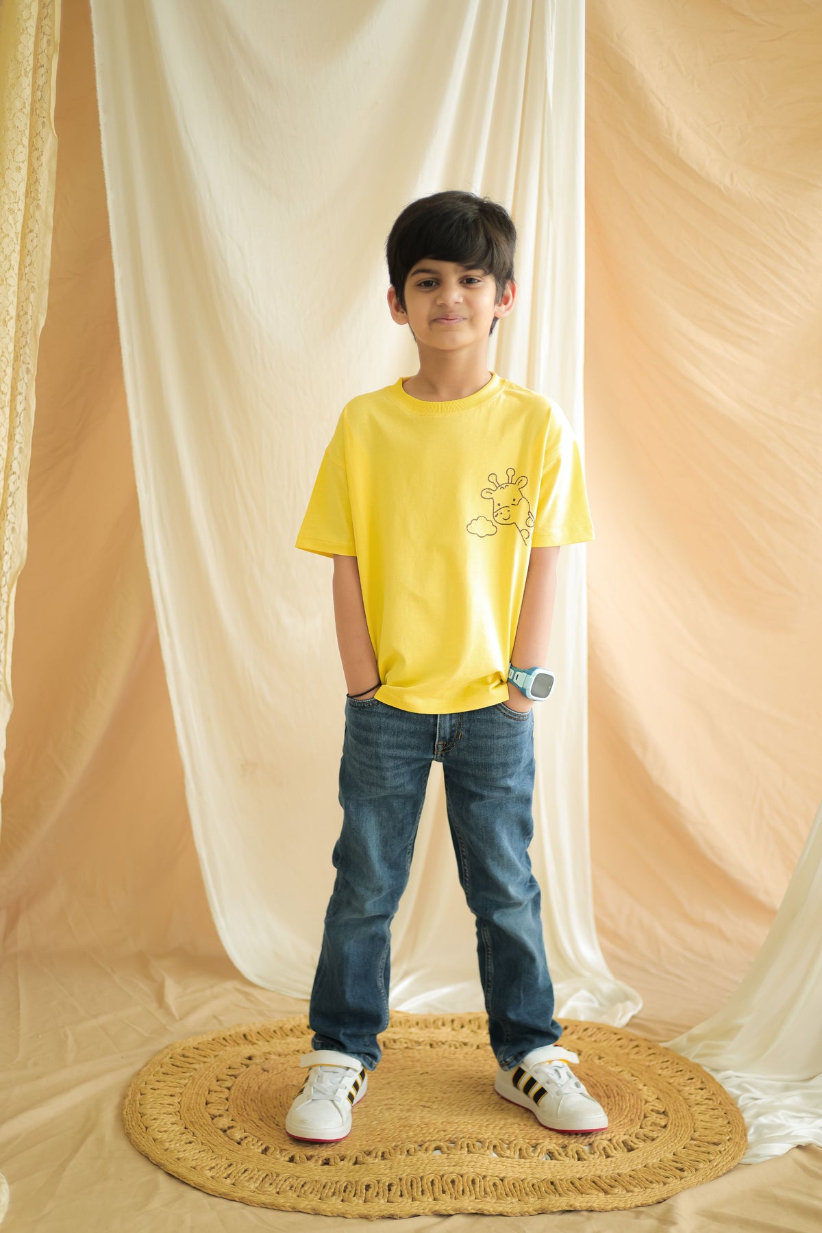 Yellow kids comfort tee with giraffe and cloud line embroidery, front view