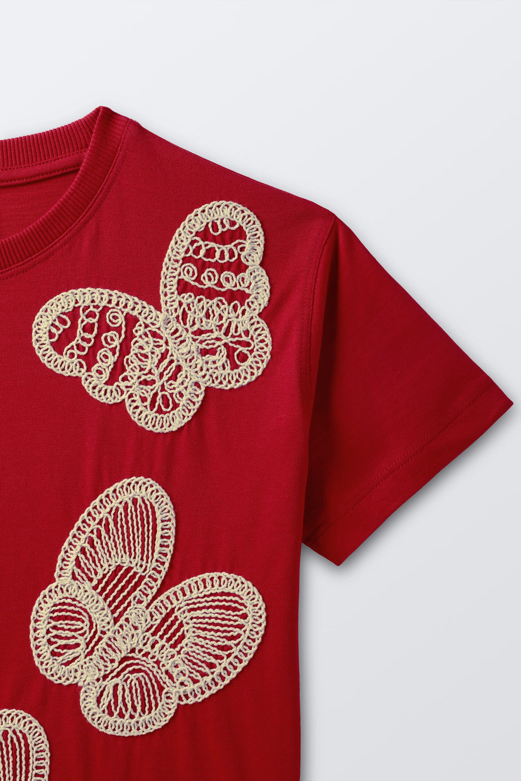 Red short-sleeve tee with white butterfly embroidery on chest and shoulder