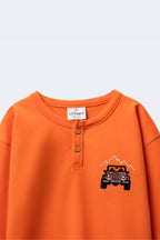 Boys orange henley T-shirt with front button placket and off-road car embroidery