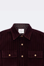Burgundy corduroy boys button-up with two chest pockets and patterned inner collar