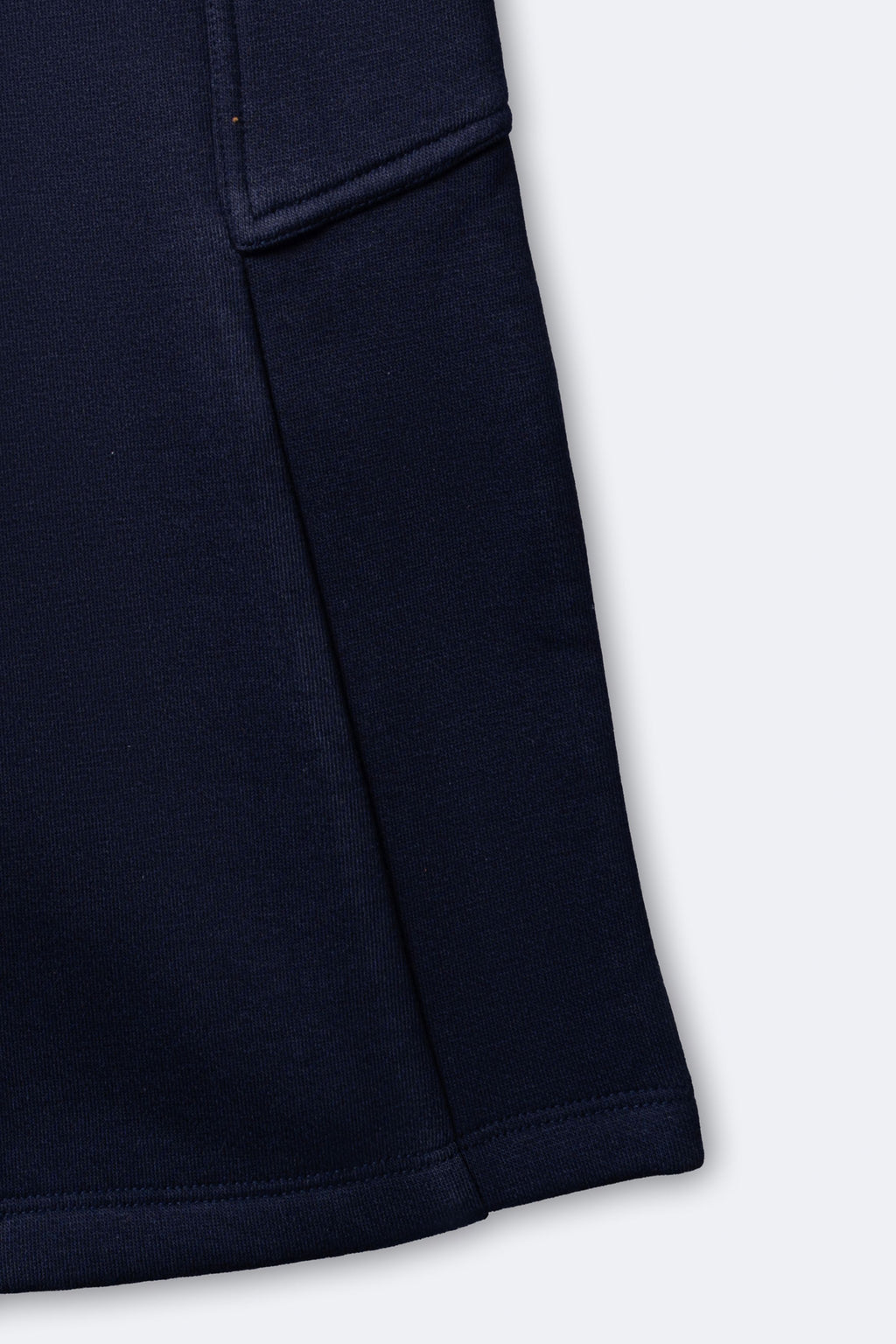 Navy fleece pajama pant leg with cargo pocket and stitched hem