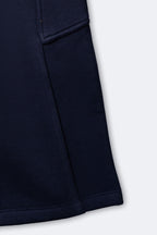 Navy fleece pajama pant leg with cargo pocket and stitched hem
