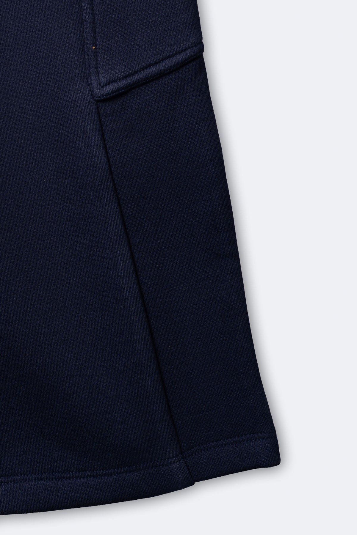 Navy fleece pajama pant leg with cargo pocket and stitched hem