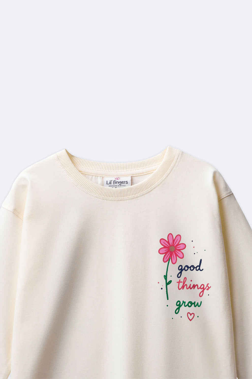 Off-white long-sleeve tee with partial “good things grow” floral graphic