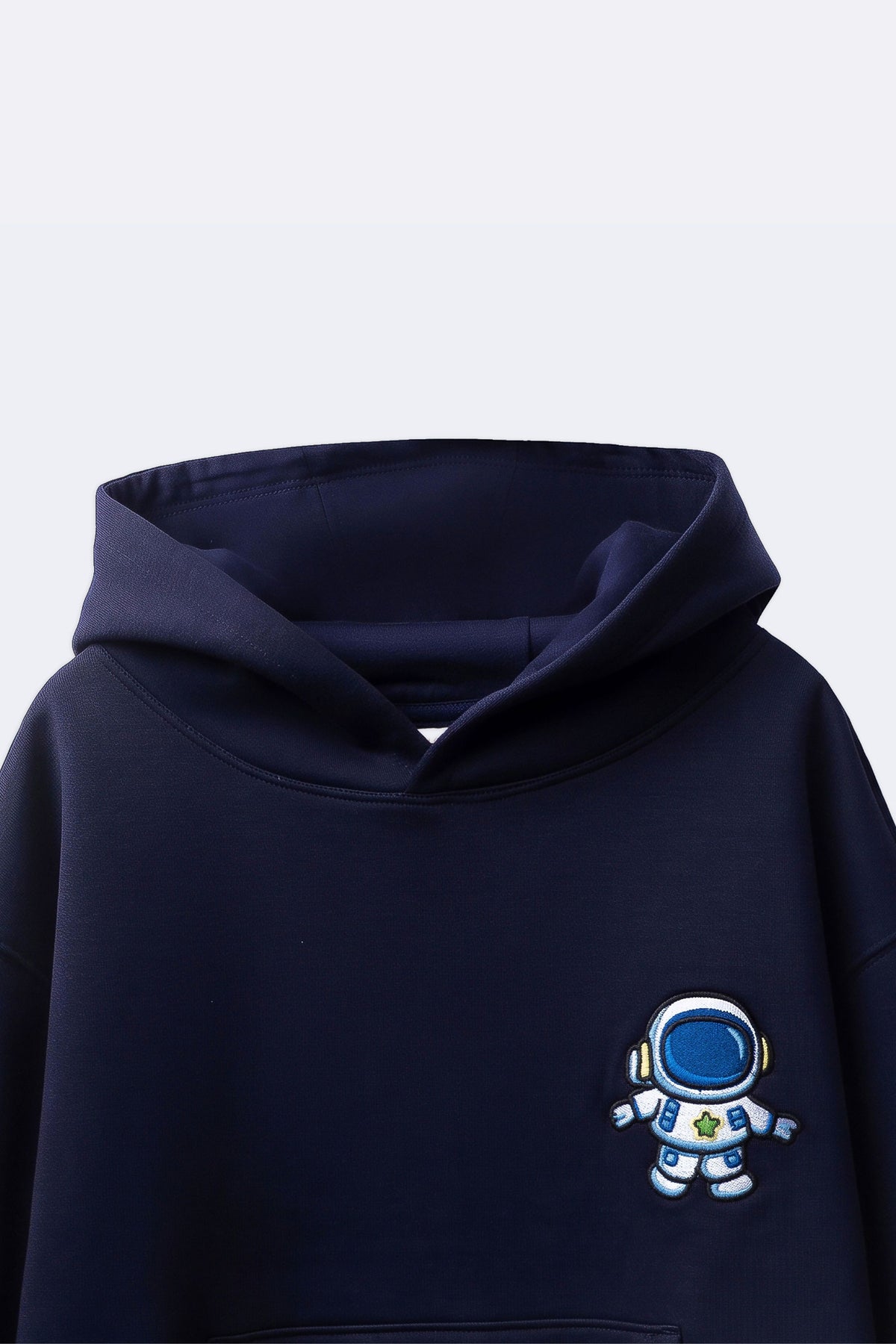 Navy hoodie close-up with blue astronaut embroidery on chest