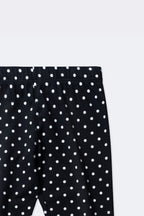 Black polka dot leggings close-up with ruched elastic waistband and allover dots