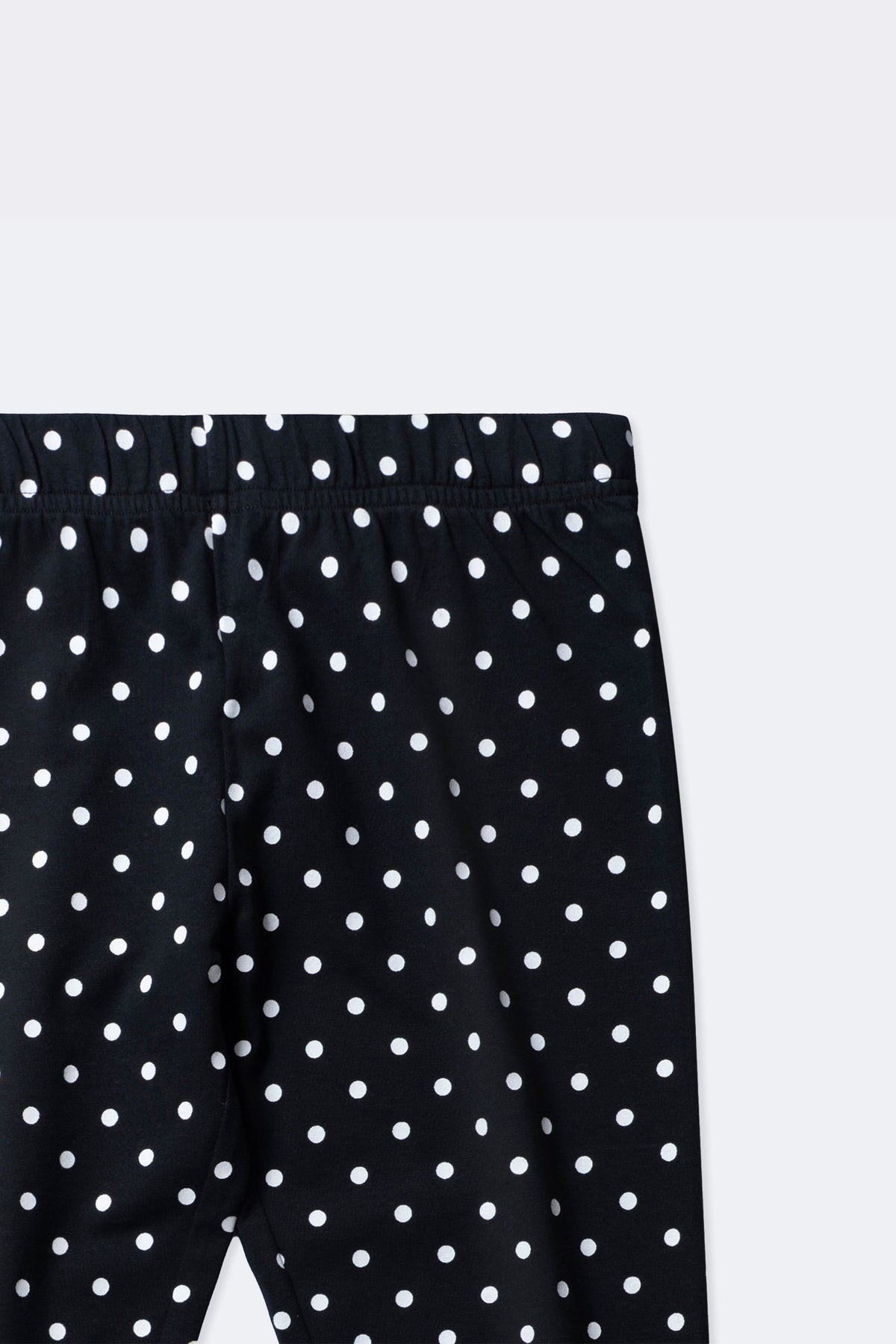 Black polka dot leggings close-up with ruched elastic waistband and allover dots