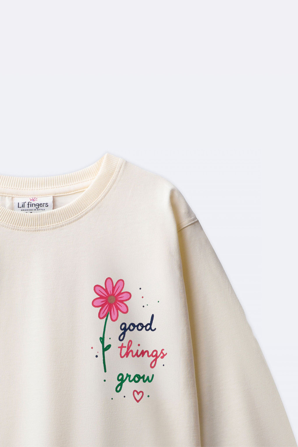 Off-white long-sleeve tee with “good things grow” pink flower graphic detail