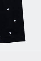 Black leggings with mini white hearts print, visible side and straight hem