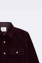 Burgundy corduroy button-up with contrast patterned cuff and chest patch pocket