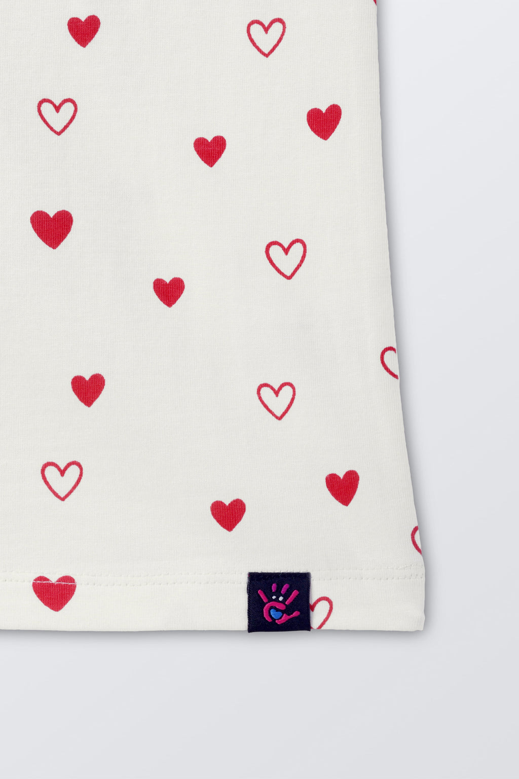 Off-white comfort tee hem detail with red hearts print and brand tag label