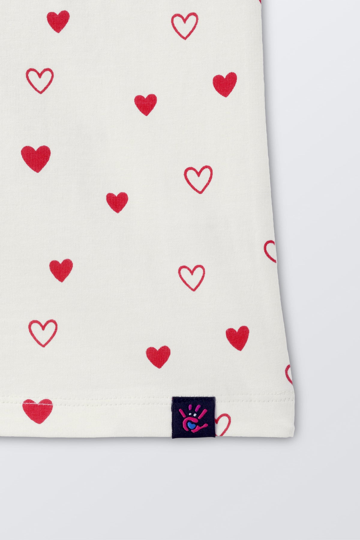 Off-white comfort tee hem detail with red hearts print and brand tag label