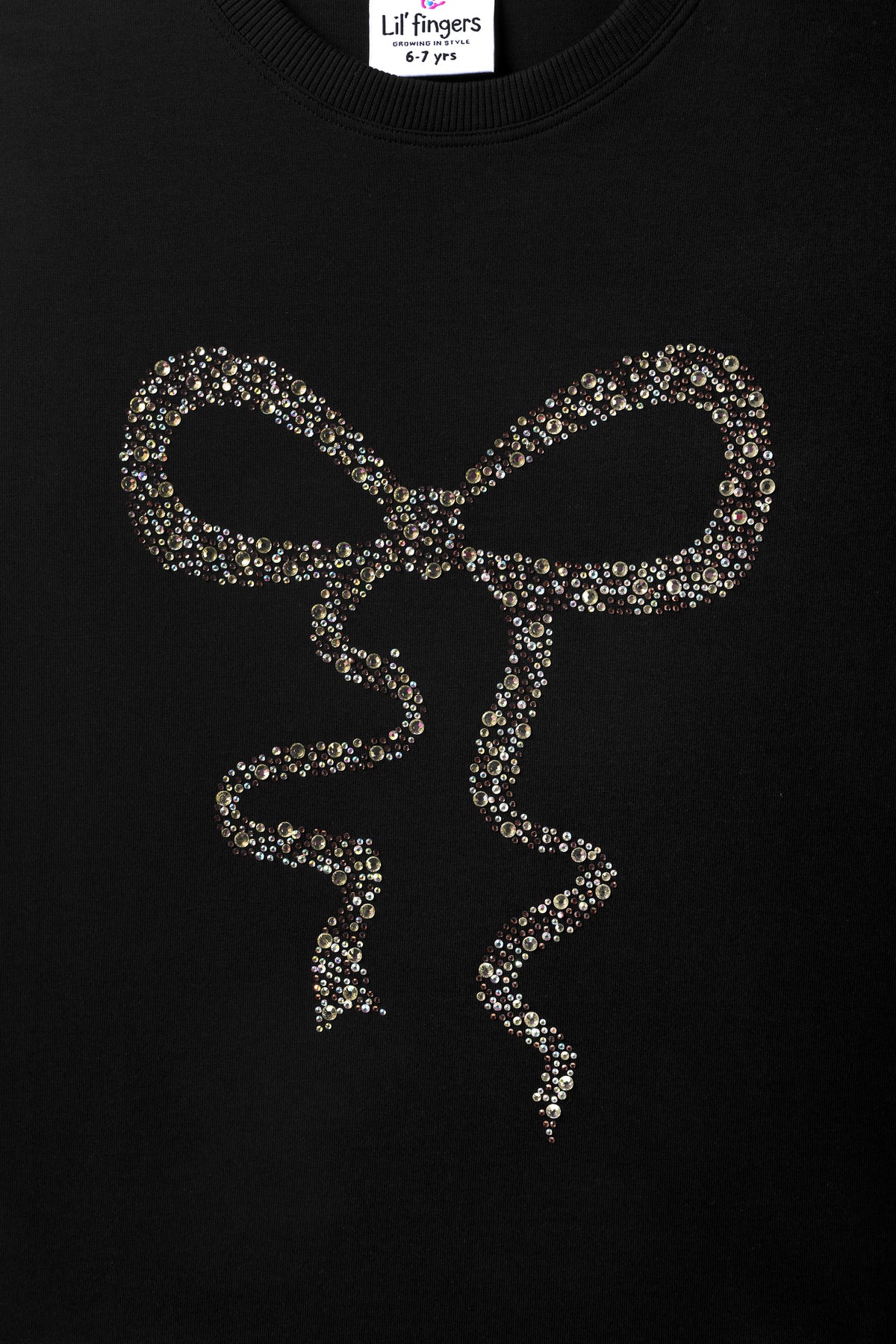 Black long-sleeve tee with centered gold-toned bead bow and ribbon drops