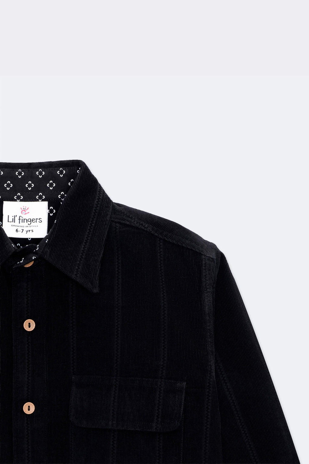 Black corduroy shirt with pointed collar, twin flap pockets and wooden-look buttons