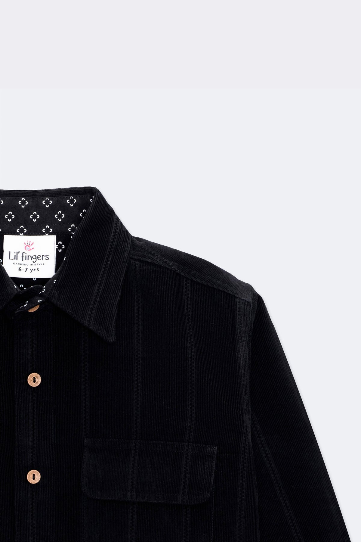 Black corduroy shirt with pointed collar, twin flap pockets and wooden-look buttons
