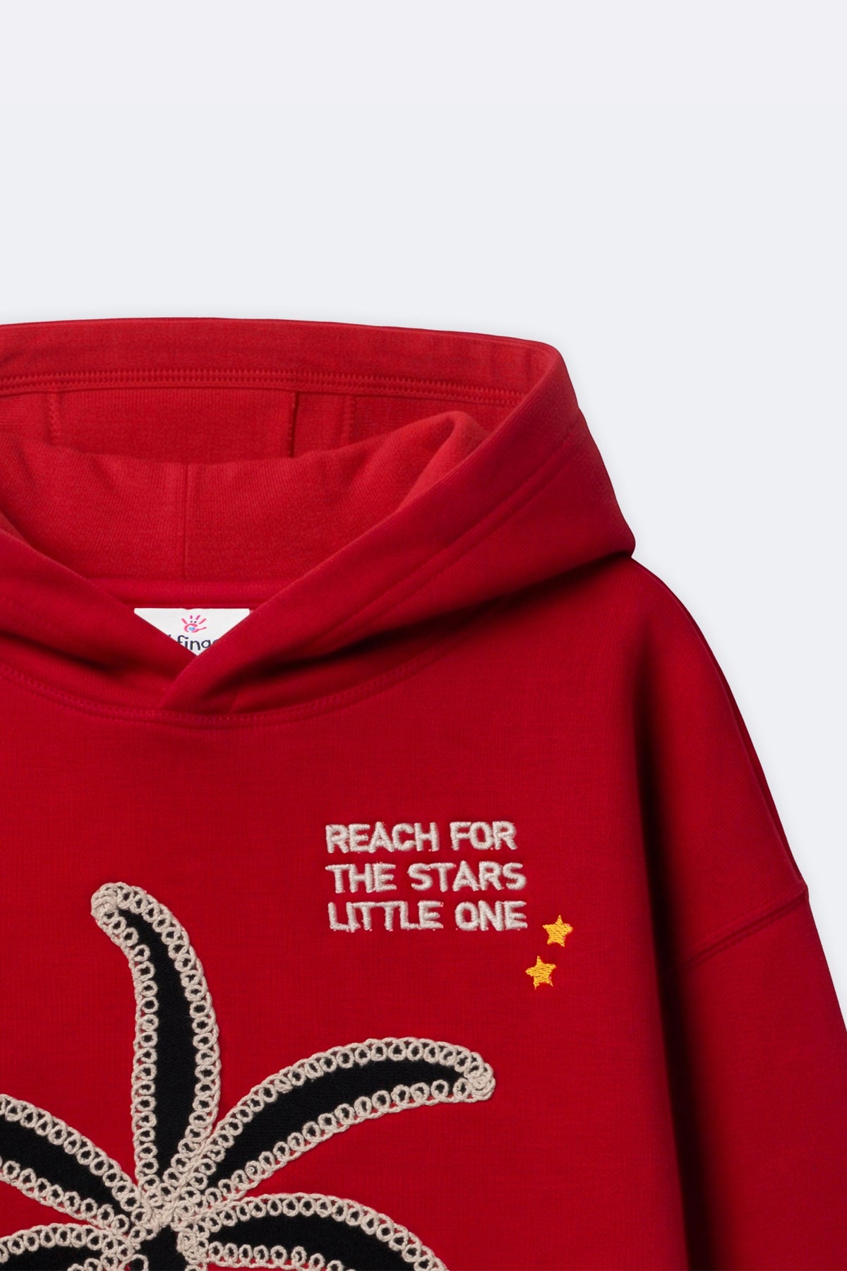 Red fleece hoodie with 'Reach for the stars' chest print and small star accents