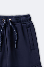 Navy fleece pajama pants with elastic waistband and drawstring with metal eyelets