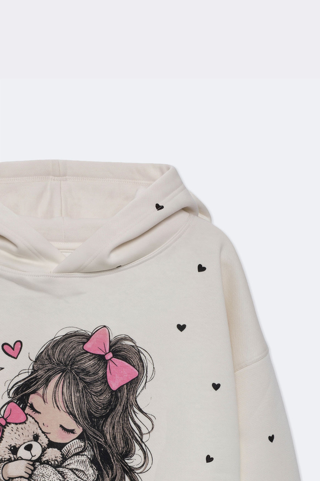 Off-white girls' hoodie sleeve close-up with small heart print