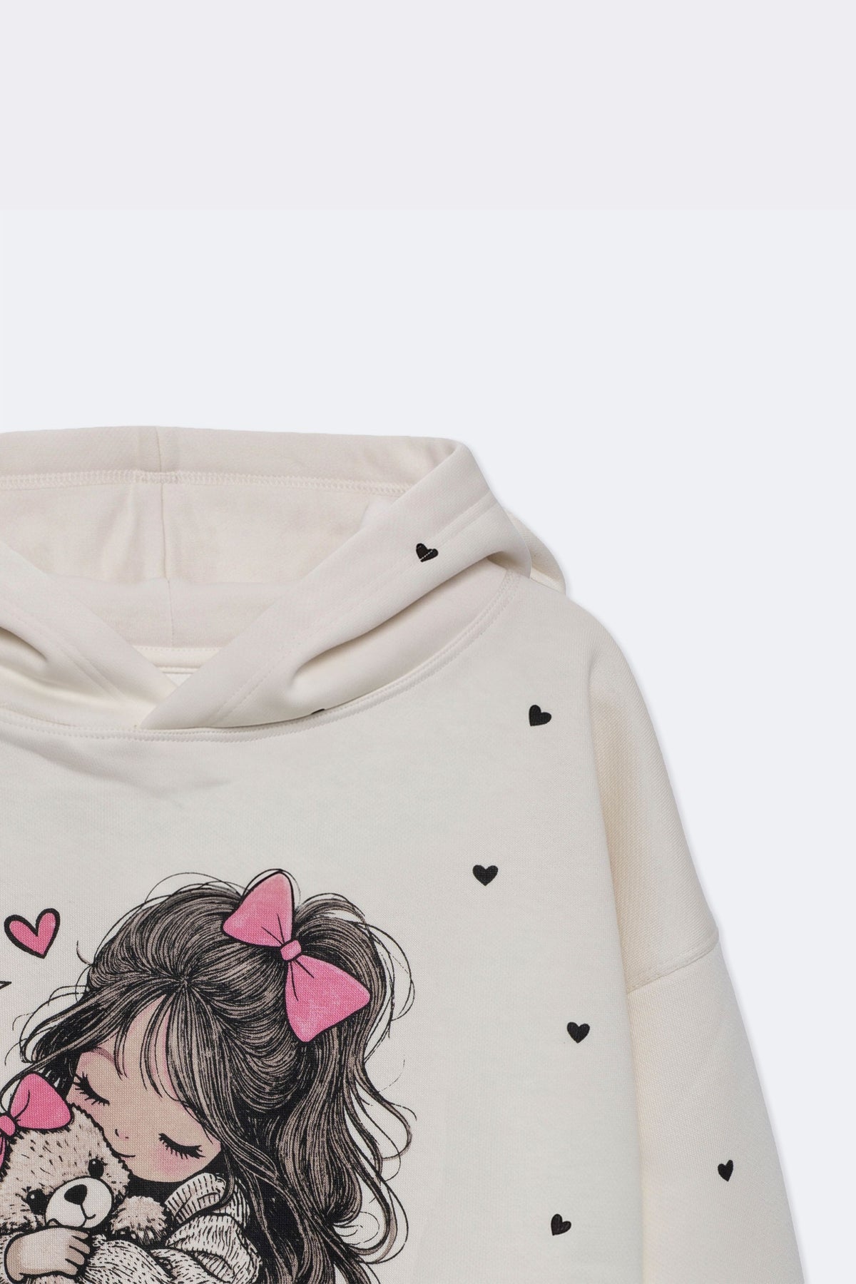 Off-white girls' hoodie sleeve close-up with small heart print