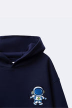 Navy hoodie close-up with astronaut embroidery on front pocket area