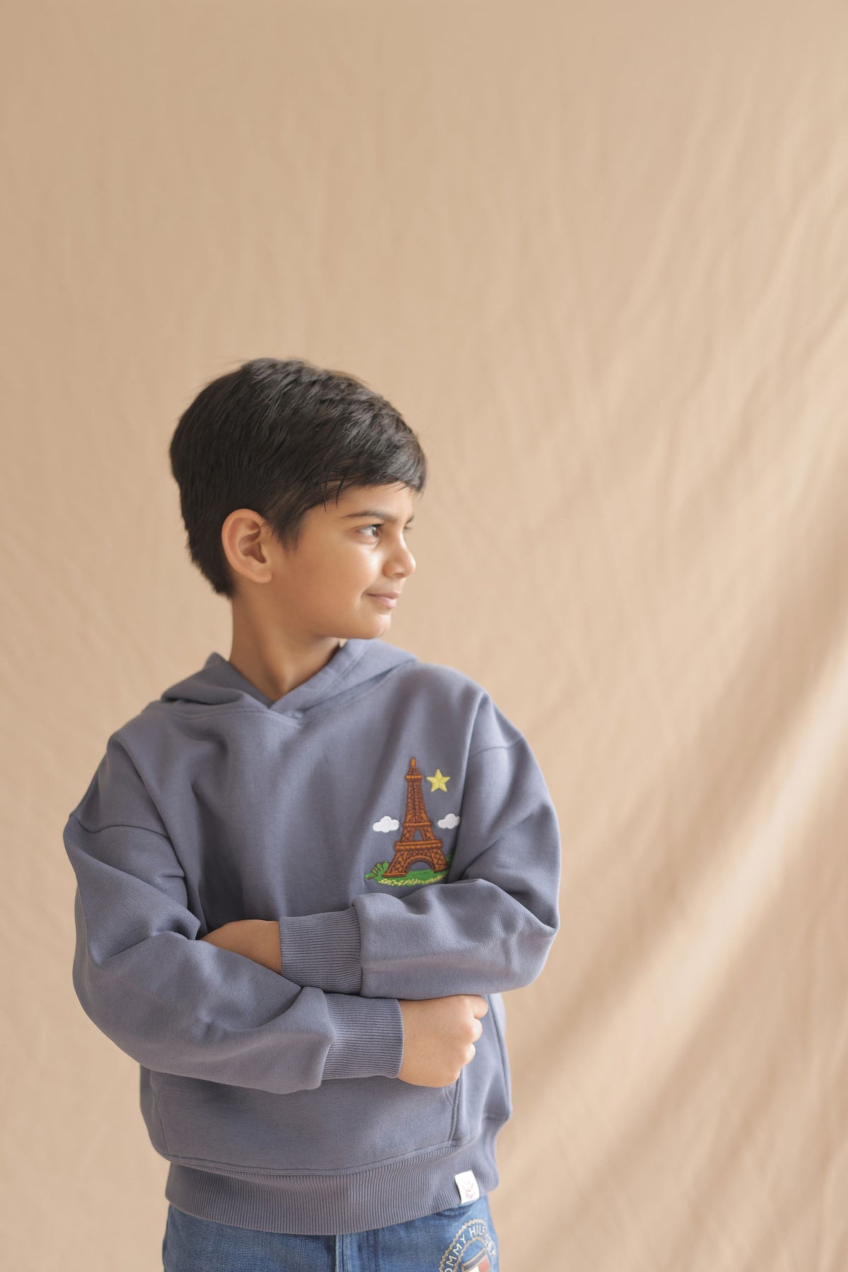 Denim blue kids hoodie with hood, Eiffel tower embroidery, worn by child model
