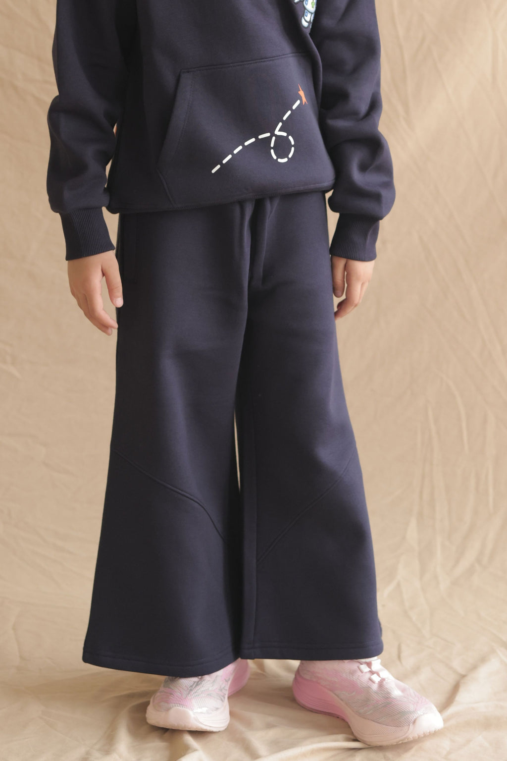 Navy fleece palazzo pants worn with kids sneakers, wide flare legs and side pockets