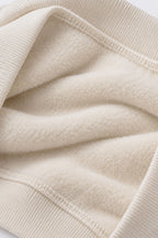 Off-white fleece sweatshirt fabric close-up with ribbed hem and cuffs