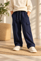 Navy fleece pajama pants on model, cargo pockets and adjustable drawstring waist