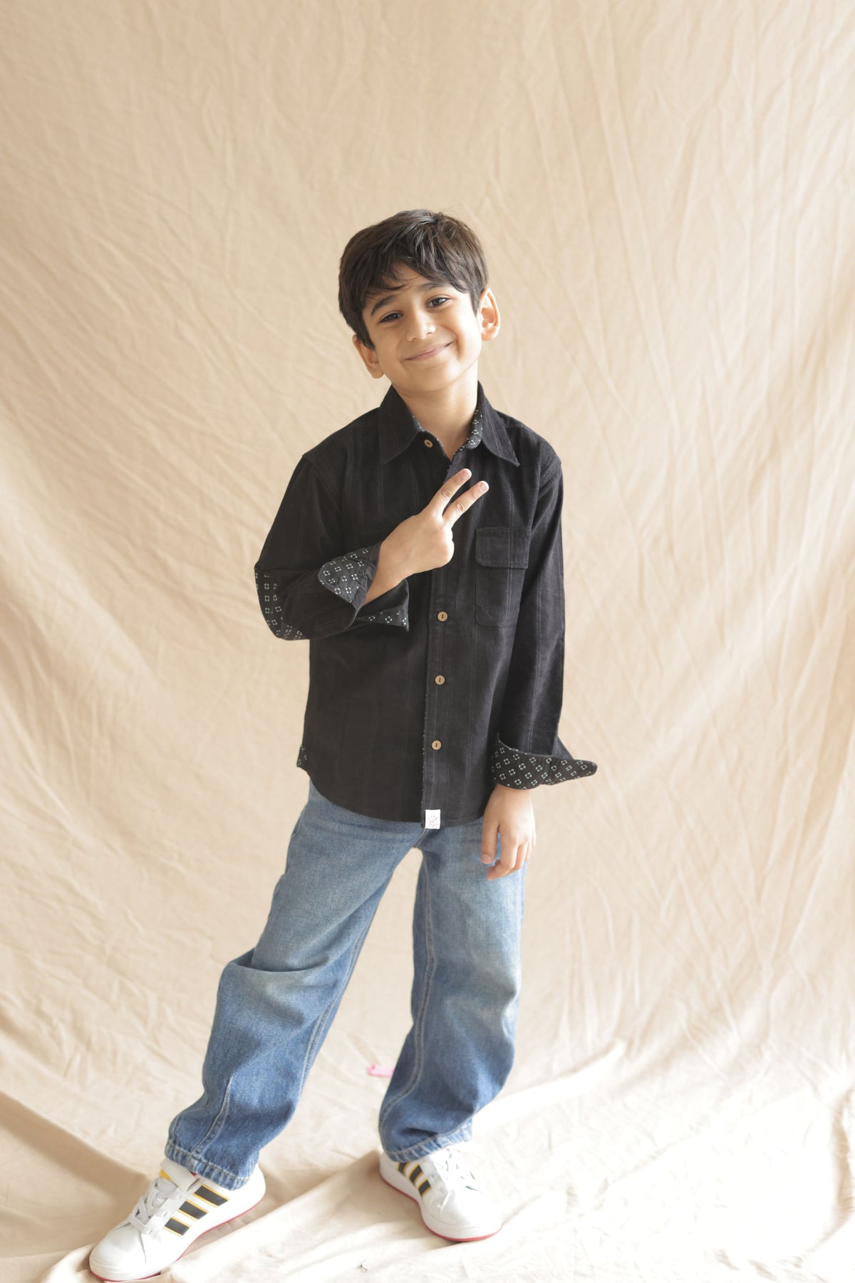 Black corduroy full-sleeve shirt with button front and twin flap pockets