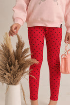Girls red polka dot stretch leggings, worn with elastic waist