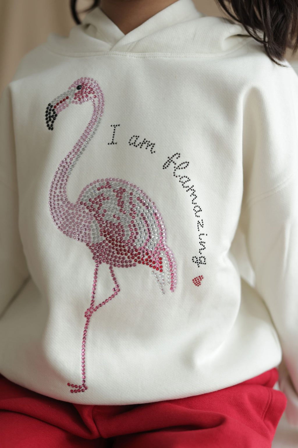 Ivory cream girls hoodie close-up of rhinestone flamingo and “I am” text