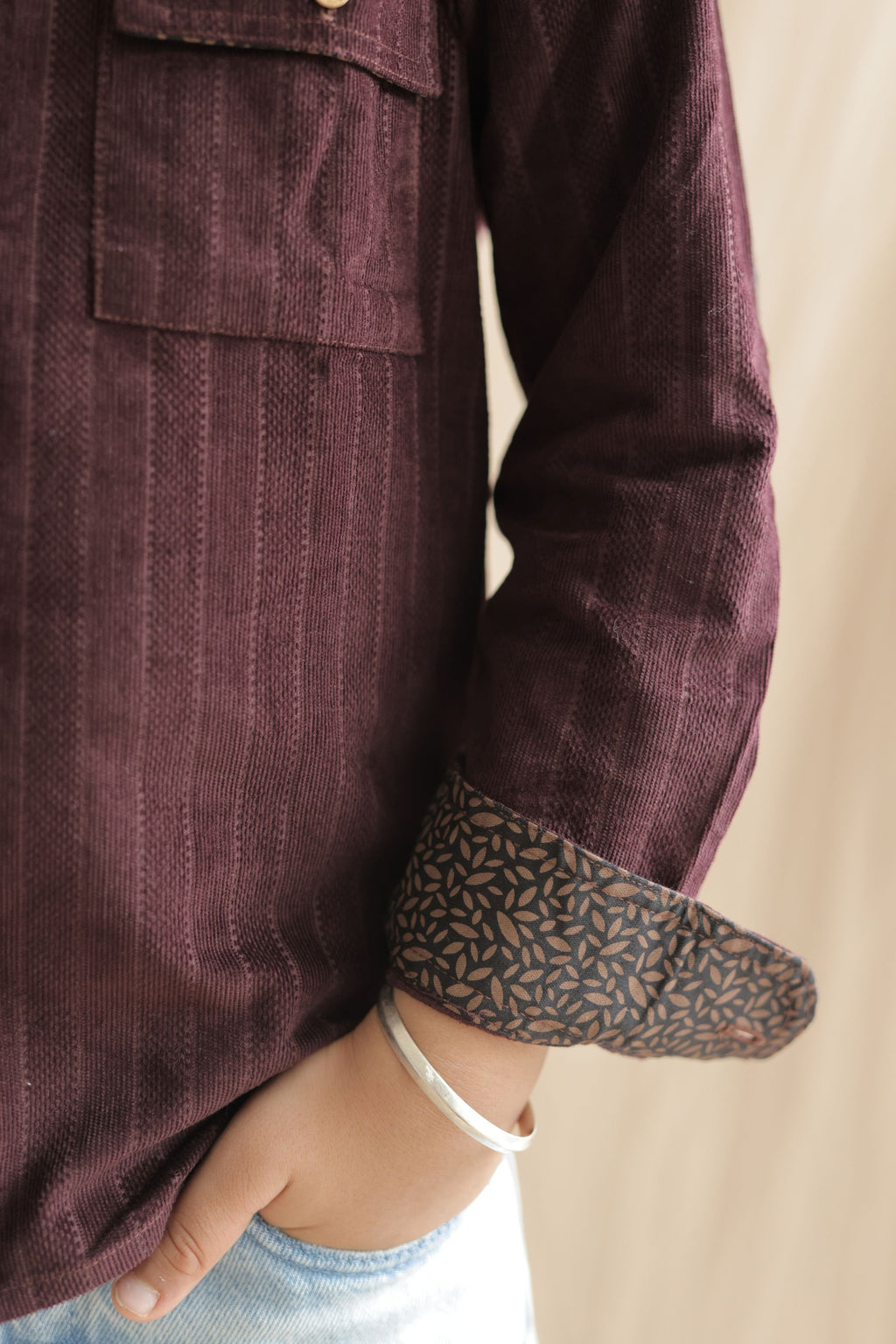 Burgundy corduroy shirt sleeve with contrast patterned cuff and elbow patch