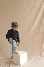 Boys navy corduroy button-up shirt with long sleeves, gold buttons, and flap pockets