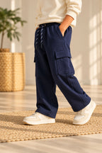 Navy fleece pajama pants on model, cargo side pockets and relaxed leg fit