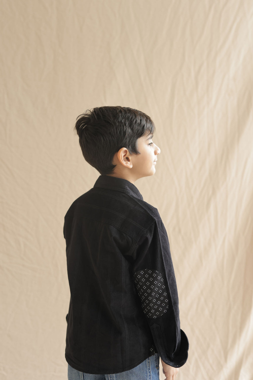 Black corduroy shirt with printed elbow patch and button front