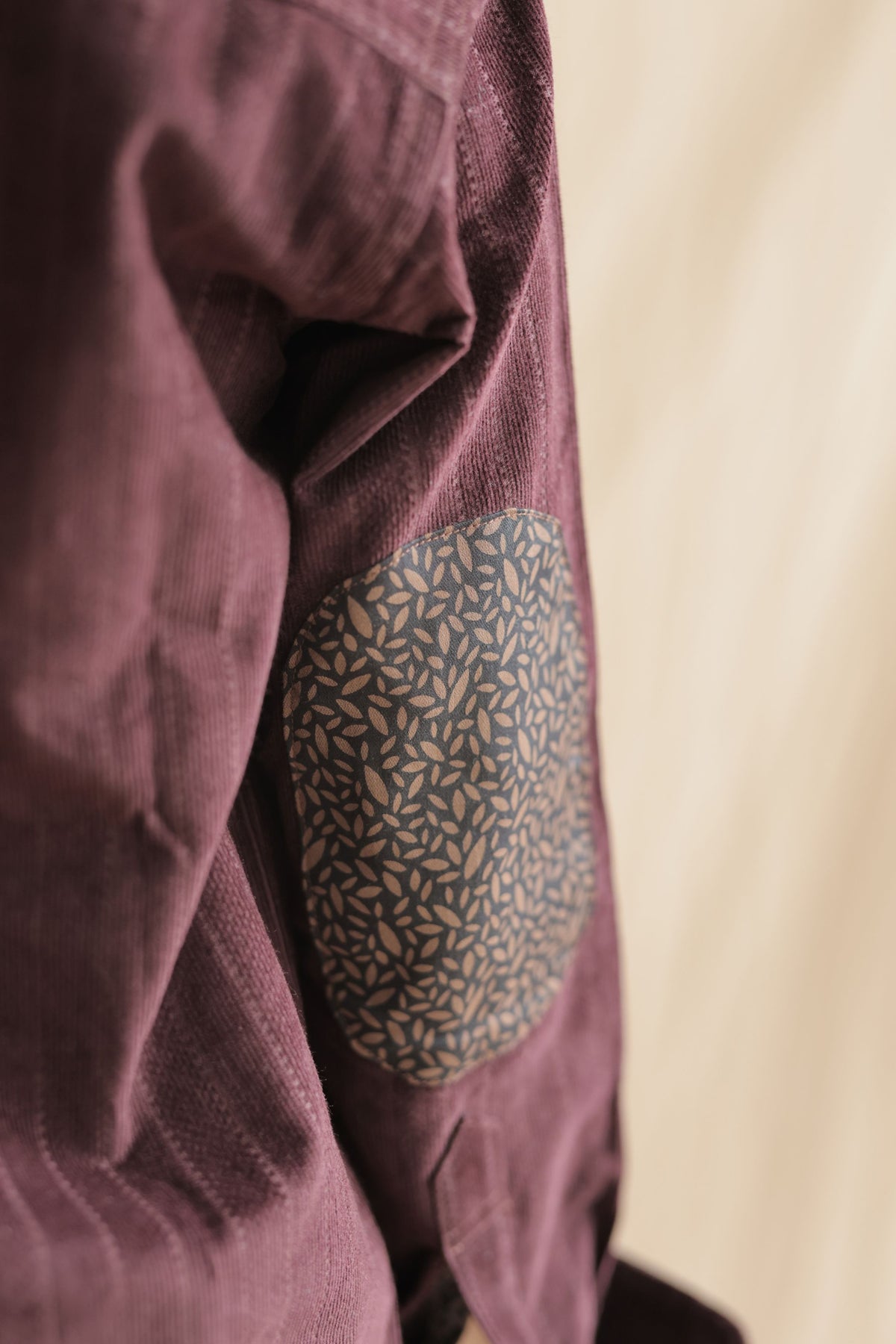 Contrast patterned pocket and burgundy corduroy shirt sleeve