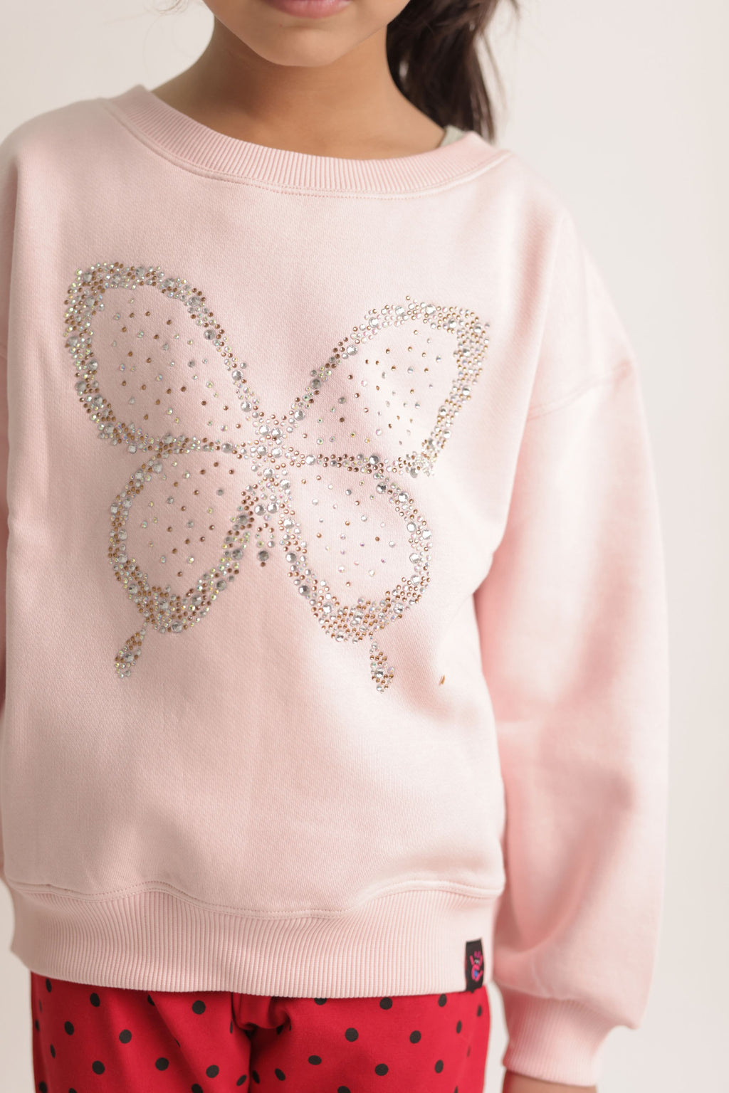 Girl's blush pink sweatshirt featuring a sparkling butterfly beadwork design