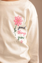 Off-white long-sleeve tee with “good things grow” pink flower dotted graphic