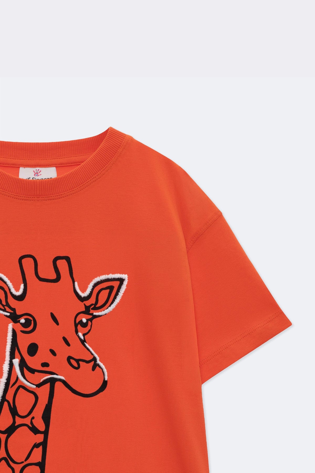 Orange comfort tee with embroidered giraffe graphic detail on the chest