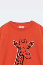 Orange comfort tee close-up: embroidered giraffe graphic on the front