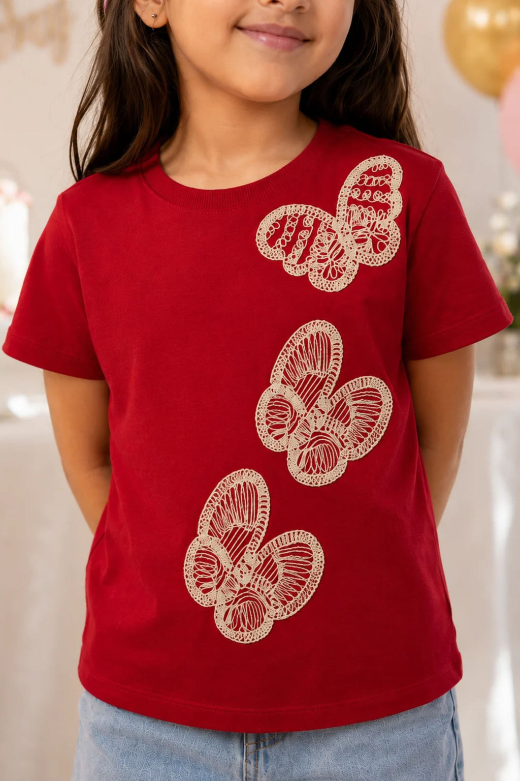 Red short-sleeve tee with three white embroidered butterflies and crew neckline