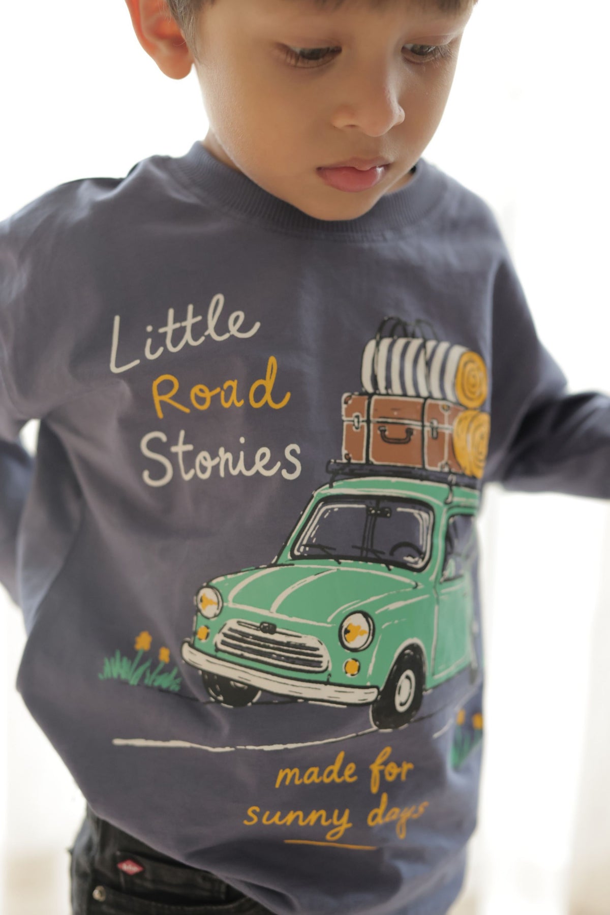 Dusty blue long-sleeve tee with Little Road Stories bus graphic on child